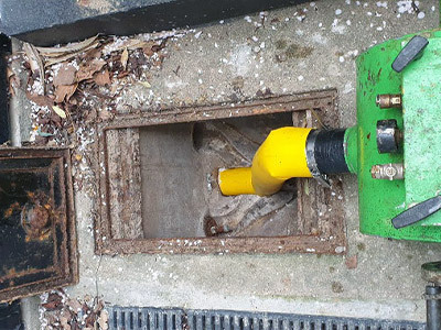 High-pressure jetting machine clearing clogged drain in London home